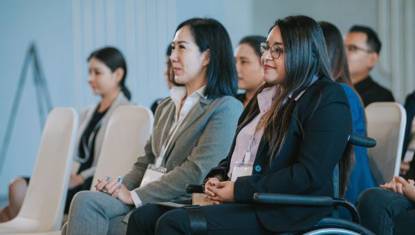 Woman attending entrepreneur conference in wheelchair